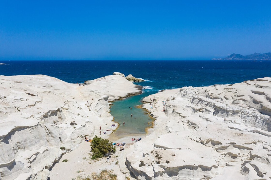 The white lunar rock of Sarakiniko dropping into the Aegean on Milos