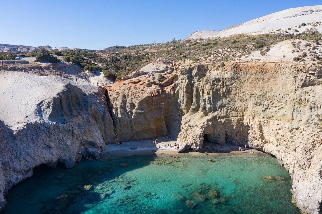 A hidden turquoise cove between cliffs in the Western Cyclades